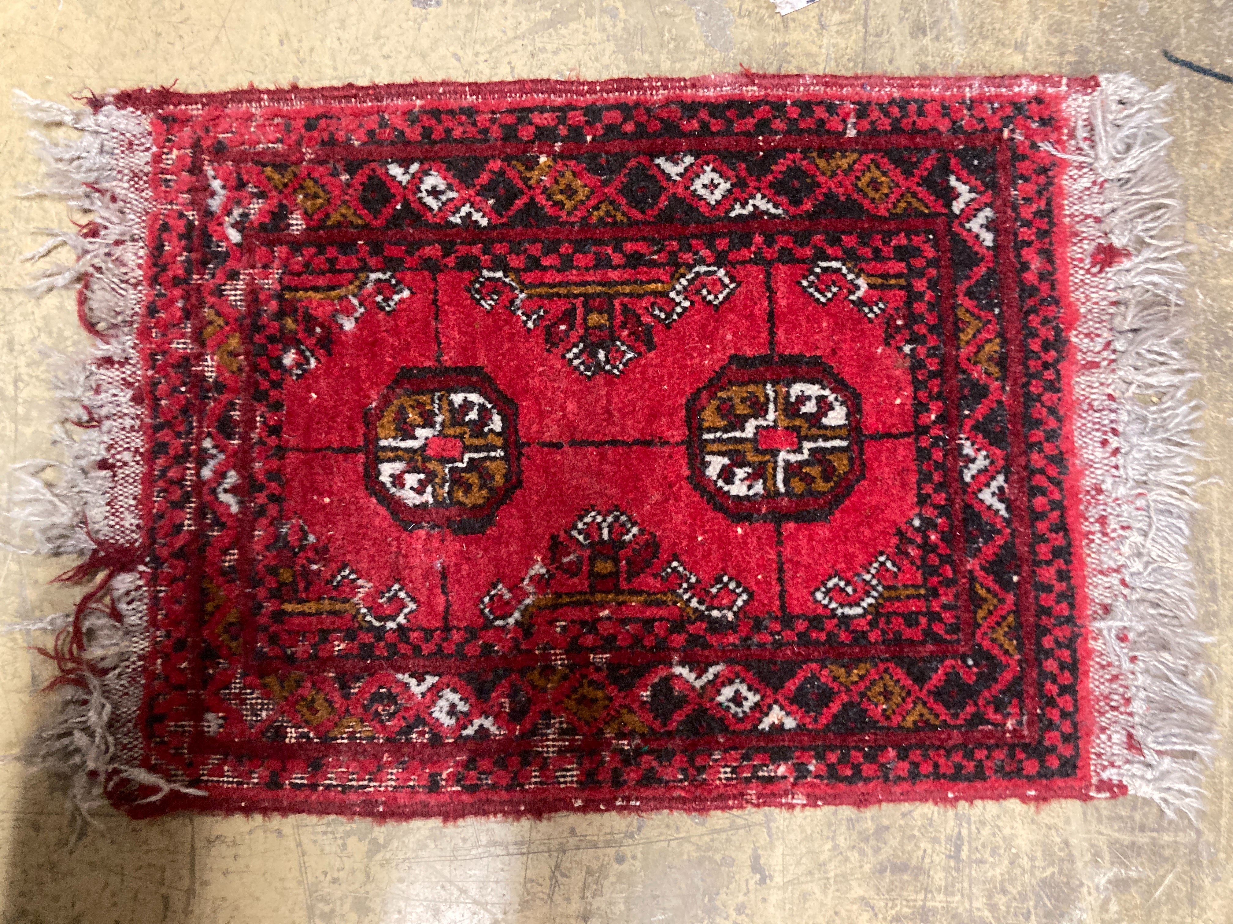 A Bokhara wall hanging 54 x 70 cms, one other, two Bokhara mats and bag.